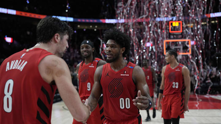 Dec 26, 2024; Portland, Oregon, USA; Portland Trail Blazers guard Scoot Henderson (00) celebrates with small forward Deni Avdija (8) after making the game-winning basket against the Utah Jazz at Moda Center. Mandatory Credit: Soobum Im-Imagn Images