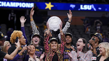 Apr 2, 2023; Dallas, TX, USA; LSU Lady Tigers head coach Kim Mulkey celebrates with a trophy after defeating the Iowa Hawkeyes during the final round of the Women's Final Four NCAA tournament at the American Airlines Center. Mandatory Credit: Kirby Lee-Imagn Images