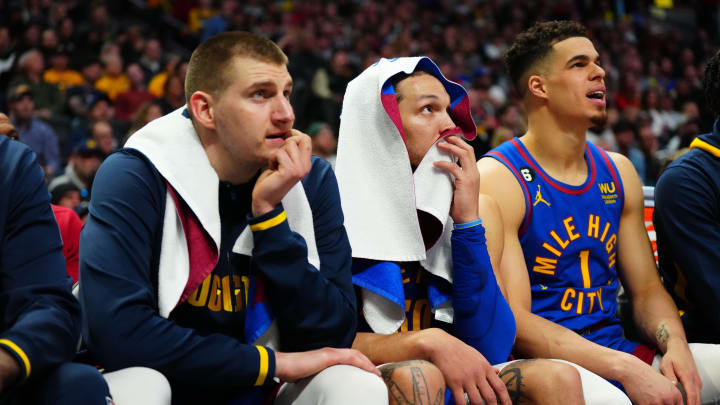 Denver Nuggets center Nikola Jokic (15) and  forward Aaron Gordon (50) and forward Michael Porter Jr. (1) on the bench during the fourth quarter against the Milwaukee Bucks at Ball Arena. Mandatory Credit: