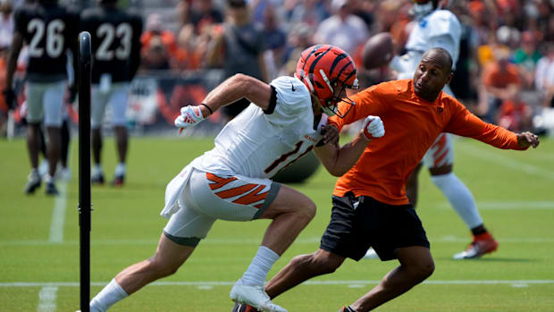 Bengals wide receivers coach runs a drill with receiver Trenton Irwin.