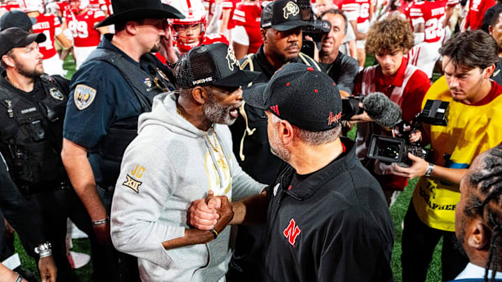 Sep 7, 2024; Lincoln, Nebraska, USA; Colorado Buffaloes head coach Deion Sanders and Nebraska Cornhuskers head coach Matt Rhule shake hands after the Cornhuskers defeat the Buffaloes at Memorial Stadium. 