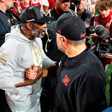 Sep 7, 2024; Lincoln, Nebraska, USA; Colorado Buffaloes head coach Deion Sanders and Nebraska Cornhuskers head coach Matt Rhule shake hands after the Cornhuskers defeat the Buffaloes at Memorial Stadium.