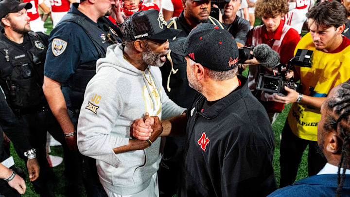 Sep 7, 2024; Lincoln, Nebraska, USA; Colorado Buffaloes head coach Deion Sanders and Nebraska Cornhuskers head coach Matt Rhule shake hands after the Cornhuskers defeat the Buffaloes at Memorial Stadium.