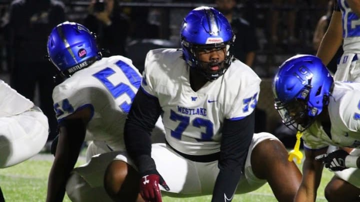 Four-star offensive line recruit Juan Gaston Jr. sits in a stance during a game for Westlake High School