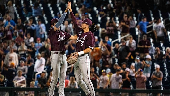 Jun 19, 2024; Omaha, NE, USA; Texas A&M Aggies second  baseman Jack Bell (1) and shortstop Ali Camarillo (2) celebrate after defeating the Florida Gators to make it to the championship at Charles Schwab Field Omaha. Mandatory Credit: Dylan Widger-USA TODAY Sports