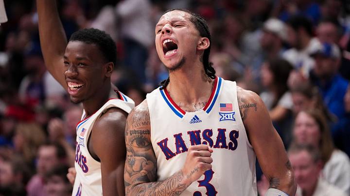 Dec 22, 2025; Lawrence, Kansas, USA; Kansas Jayhawks guard Melvin Council Jr. (14) and guard Tre White (3) celebrate on the bench against the Davidson Wildcats during the second half of the game at Allen Fieldhouse. Mandatory Credit: Denny Medley-Imagn Images