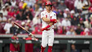 May 4, 2025; Cincinnati, Ohio, USA;  Cincinnati Reds second baseman Matt McLain (9) tosses his bat as he draws a walk against the Washington Nationals in the fifth inning at Great American Ball Park. Mandatory Credit: Aaron Doster-Imagn Images