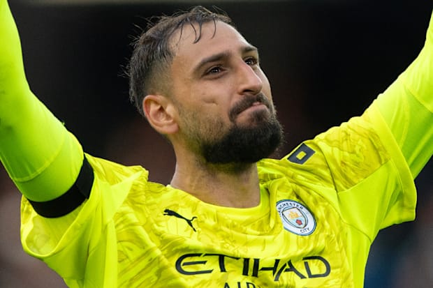 Gianluigi Donnarumma with raised arms and clenched fists.