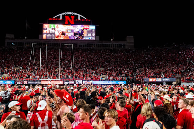 Nebraska Cornhuskers fans storm the field after defeating the Colorado Buffaloes at Memorial Stadium.