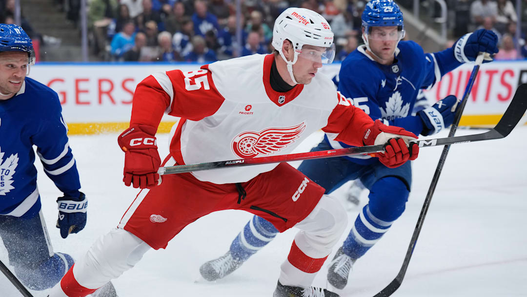 Elmer Soderblom (85) battles multiple members of the Toronto Maple Leafs for the puck. Elmer Soderblom (85) battles multiple members of the Toronto Maple Leafs for the puck.