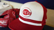 Apr 5, 2025; Milwaukee, Wisconsin, USA;  General view of a Cincinnati Reds cap in the dugout prior to the game against the Milwaukee Brewers at American Family Field. Mandatory Credit: Jeff Hanisch-Imagn Images