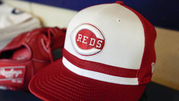 Apr 5, 2025; Milwaukee, Wisconsin, USA;  General view of a Cincinnati Reds cap in the dugout prior to the game against the Milwaukee Brewers at American Family Field. Mandatory Credit: Jeff Hanisch-Imagn Images
