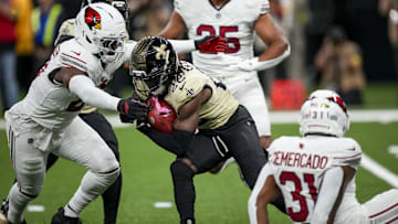Sep 7, 2025; New Orleans, Louisiana, USA; New Orleans Saints wide receiver Rashid Shaheed (22) is tackled by Arizona Cardinals running back Michael Carter (22) during the first quarter at Caesars Superdome. Mandatory Credit: Matthew Hinton-Imagn Images
