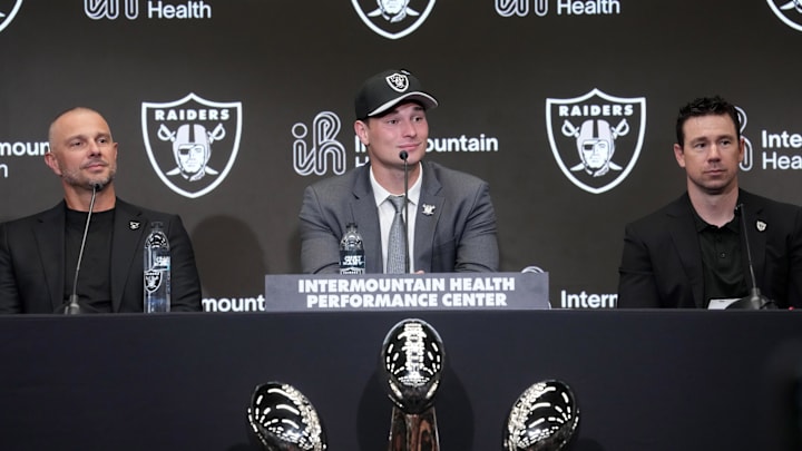 Apr 24, 2026; Henderson, NV, USA; Las Vegas Raiders quarterback Fernando Mendoza (center) speaks at introductory press conference at Intermountain Health Performance Center flanked by general manager John Spytek (left) and head coach Klint Kubiak after being selected as the No. 1 pick in the 2026 NFL Draft. Mandatory Credit: Kirby Lee-Imagn Images