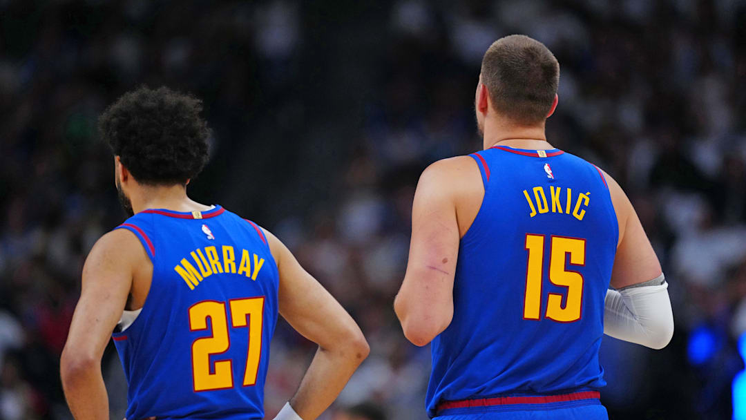 May 3, 2025; Denver, Colorado, USA; Denver Nuggets guard Jamal Murray (27) and Denver Nuggets center Nikola Jokic (15) during the first quarter against the LA Clippers during game seven of first round for the 2025 NBA Playoffs at Ball Arena. Mandatory Credit: Ron Chenoy-Imagn Images