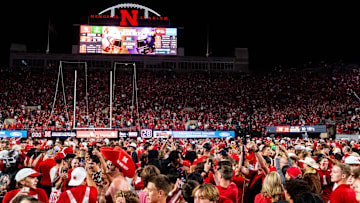 Sep 7, 2024; Lincoln, Nebraska, USA; Nebraska Cornhuskers fans storm the field after defeating the Colorado Buffaloes at Memorial Stadium. 