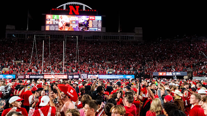 Sep 7, 2024; Lincoln, Nebraska, USA; Nebraska Cornhuskers fans storm the field after defeating the Colorado Buffaloes at Memorial Stadium. 