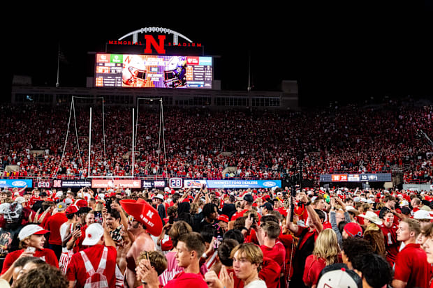 Nebraska Cornhuskers fans storm the field after defeating the Colorado Buffaloes at Memorial Stadium.