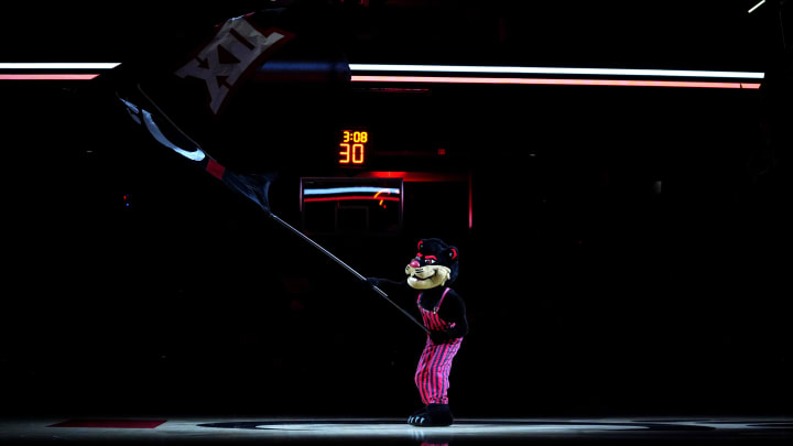 The Cincinnati Bearcats mascot waves the B12 Conference flag before a college basketball game between the TCU Horned Frogs and the Cincinnati Bearcats, Tuesday, Jan. 16, 2024, at Fifth Third Arena in Cincinnati.