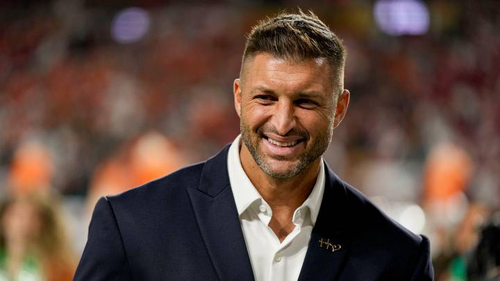 Tim Tebow stands on the sidelines Monday, Jan. 19, 2026, ahead of the College Football Playoff National Championship college football game between the Indiana Hoosiers and the Miami (FL) Hurricanes at Hard Rock Stadium in Miami Gardens.