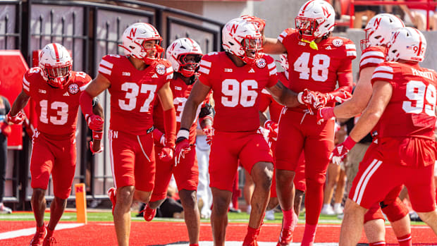 Nebraska defensive lineman Williams Nwaneri (96) and teammates celebrate the redshirt freshman's scoop-and-score touchdown.