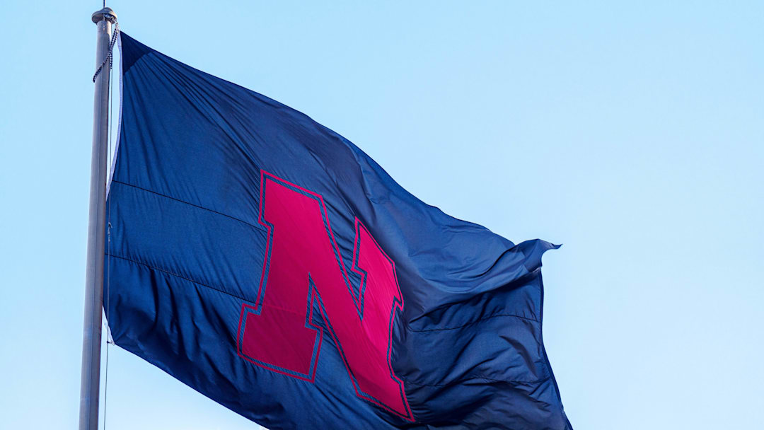 A black Nebraska Cornhuskers flag waves outside Memorial Stadium.