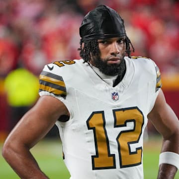 Oct 7, 2024; Kansas City, Missouri, USA; New Orleans Saints wide receiver Chris Olave (12) on the sidelines against the Kansas City Chiefs during the game at GEHA Field at Arrowhead Stadium. Mandatory Credit: Denny Medley-Imagn Images