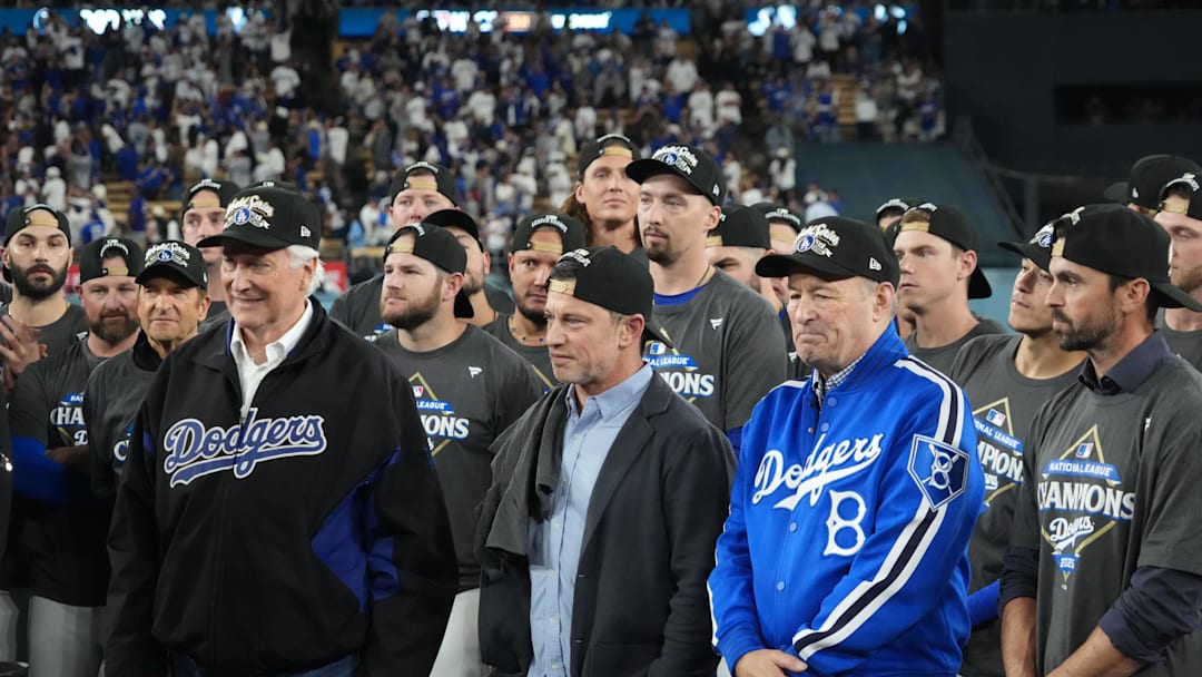 Oct 17, 2025; Los Angeles, California, USA; Los Angeles Dodgers owner Mark Walter, president of baseball operations Andrew Friedman and president Stan Kasten react after game four of the NLCS round for the 2025 MLB playoffs against the Milwaukee Brewers at Dodger Stadium. Mandatory Credit: Kirby Lee-Imagn Images Oct 17, 2025; Los Angeles, California, USA; Los Angeles Dodgers owner Mark Walter, president of baseball operations Andrew Friedman and president Stan Kasten react after game four of the NLCS round for the 2025 MLB playoffs against the Milwaukee Brewers at Dodger Stadium. Mandatory Credit: Kirby Lee-Imagn Images