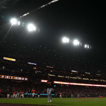 Apr 26, 2024; San Francisco, California, USA; Stadium LED lights flash as San Francisco Giants catcher Patrick Bailey (far right in orange) rounds the bases after hitting a walk-off home run against the Pittsburgh Pirates during the ninth inning at Oracle Park. Mandatory Credit: