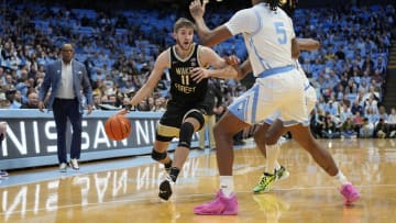 Jan 22, 2024; Chapel Hill, North Carolina, USA;  Wake Forest Demon Deacons forward Andrew Carr (11) dribbles as North Carolina Tar Heels forward Armando Bacot (5) defends in the first half at Dean E. Smith Center. Mandatory Credit: Bob Donnan-USA TODAY Sports
