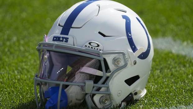 A Colts helmet (white and blue colors) sits on the practice field.