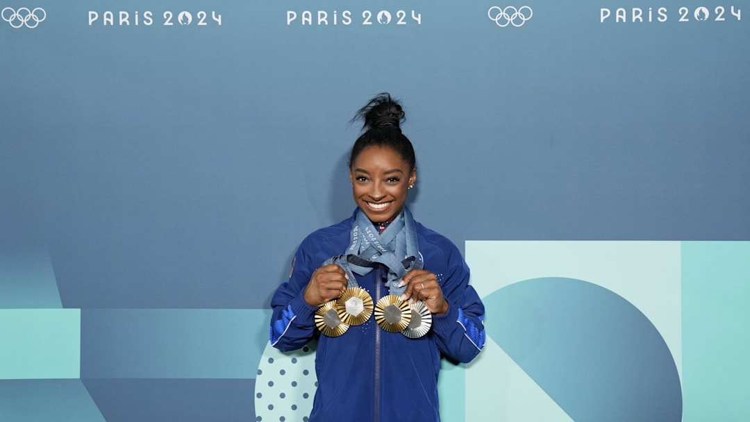 Simone Biles of the United States poses for a photo with her three gold and one silver medal after day three of the gymnastics event finals during the Paris 2024 Olympic Summer Games. 