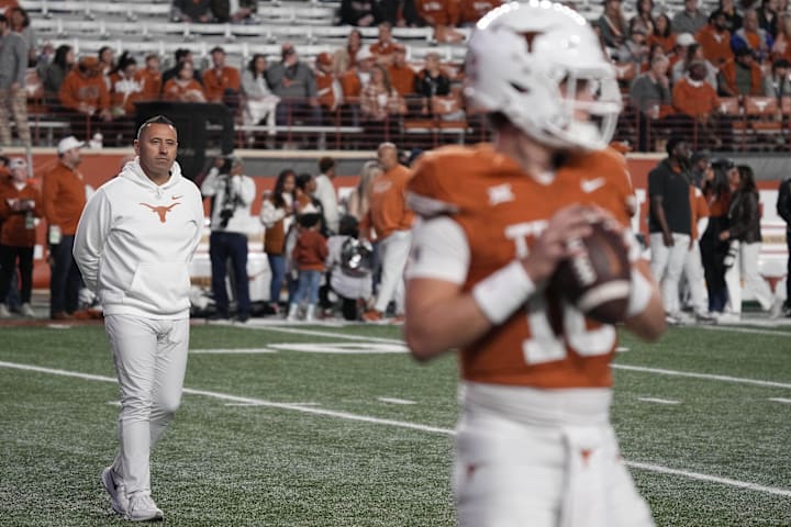 Texas Longhorns head coach Steve Sarkisian observes quarterback Arch Manning warming up before a game against the Texas Tech 