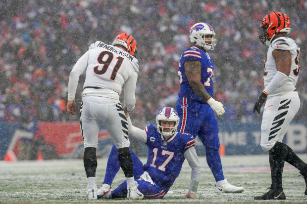 Cincinnati Bengals defensive end Trey Hendrickson (91) helps up Buffalo Bills quarterback Josh Allen