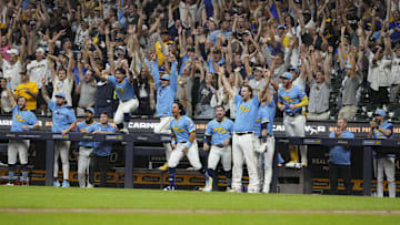 Aug 22, 2025; Milwaukee, Wisconsin, USA; The bench celebrates after a walk off home run in the ninth inning by Milwaukee Brewers catcher William Contreras (24) against the San Francisco Giants at American Family Field. Mandatory Credit: Michael McLoone-Imagn Images