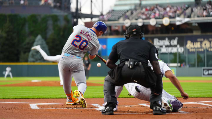 Aug 7, 2024; Denver, Colorado, USA; New York Mets first base Pete Alonso (20) RBI singles in the first inning against the Colorado Rockies at Coors Field.