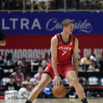 Jul 12, 2024; Las Vegas, NV, USA;  Atlanta Hawks forward/guard Nikola Durisic (7) controls the ball against Washington Wizards guard Bub Carrington (17) during the first half at Thomas & Mack Center. Mandatory Credit: Lucas Peltier-Imagn Images