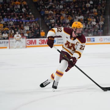 Gophers defenseman Cal Thomas (22) skating with the puck against Minnesota-Duluth.