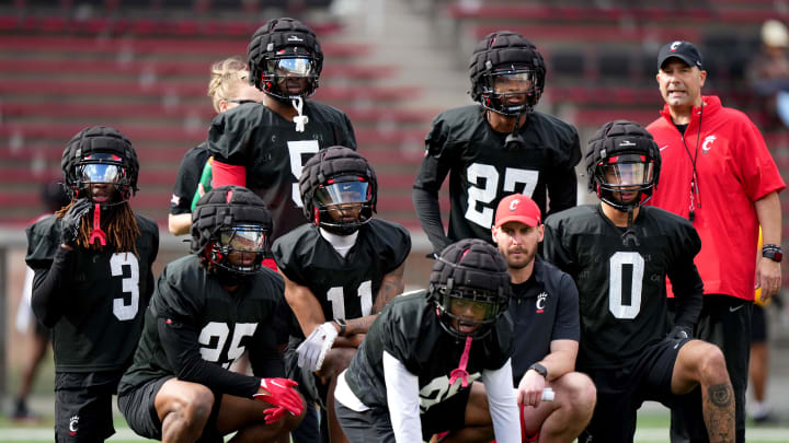 Cincinnati Bearcats defensive backs observe drills during spring football practice, Monday, March 4, 2024, at Nippert Stadium in Cincinnati.