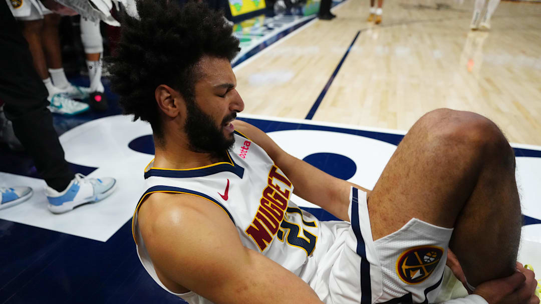 Mar 15, 2025; Denver, Colorado, USA; Denver Nuggets guard Jamal Murray (27) reacts on the baseline after a right leg injury in the fourth quarter at Ball Arena. Mandatory Credit: Ron Chenoy-Imagn Images