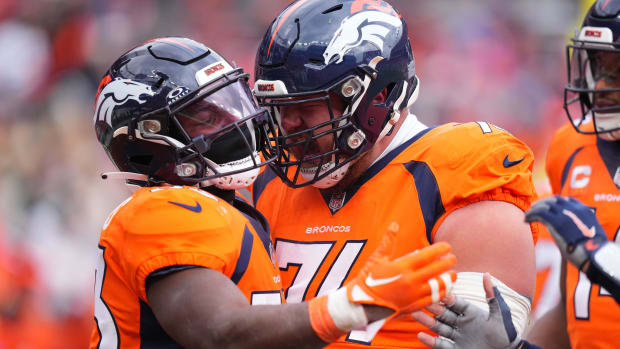 Denver Broncos running back Javonte Williams (33) celebrates his touchdown with guard Ben Powers (74).