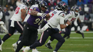 Jan 20, 2024; Baltimore, MD, USA; Houston Texans quarterback C.J. Stroud (7) runs the ball against Baltimore Ravens defensive tackle Travis Jones (98) during the first quarter of a 2024 AFC divisional round game at M&T Bank Stadium. Mandatory Credit: Mitch Stringer-USA TODAY Sports
