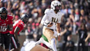 Oct 11, 2025; Cincinnati, Ohio, USA; UCF Knights quarterback Cam Fancher (14) carries the ball for a touchdown against the Cincinnati Bearcats in the second half at Nippert Stadium. Mandatory Credit: Aaron Doster-Imagn Images