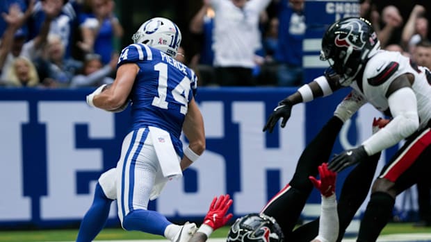 Colts receiver Alec Pierce (blue jersey; white pants) runs away from defenders into the end zone. 