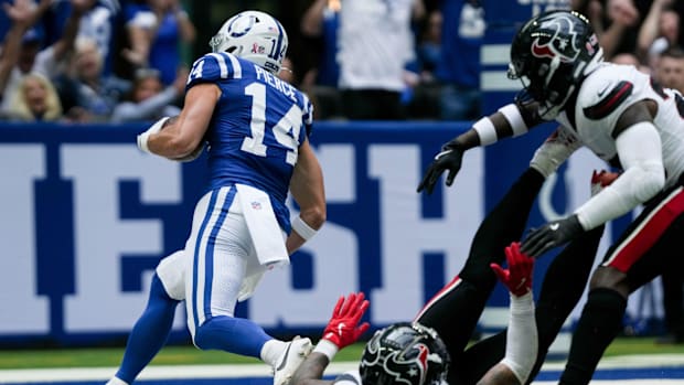 Colts receiver Alec PIerce (blue jersey; white number) scores a long touchdown after catching a pass. 