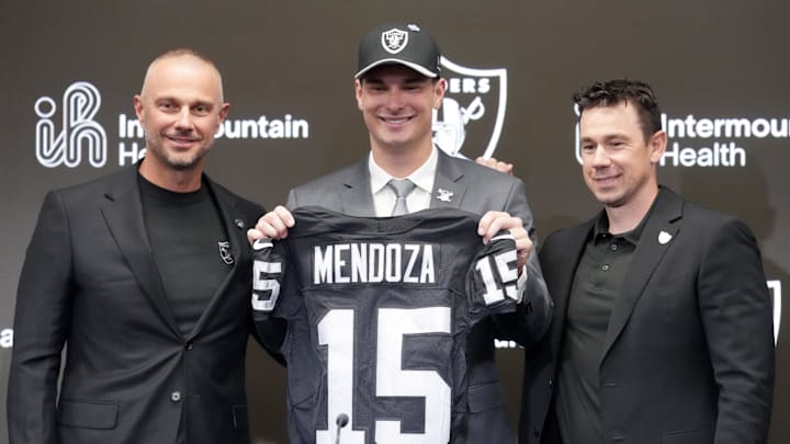 Apr 24, 2026; Henderson, NV, USA; Las Vegas Raiders quarterback Fernando Mendoza (center) poses with jersey with general manager John Spytek (left) and head coach Klint Kubiak  at introductory press conference at Intermountain Health Performance Center after being selected as the No. 1 pick in the 2026 NFL Draft. Mandatory Credit: Kirby Lee-Imagn Images