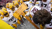 Nov 29, 2024; Madison, Wisconsin, USA;  Minnesota Golden Gophers players celebrate with the Paul Bunyan Football Trophy following the game against the Wisconsin Badgers at Camp Randall Stadium. Mandatory Credit: Jeff Hanisch-Imagn Images