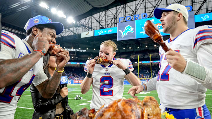 Jugadores de los Buffalo Bills comiendo el típico pavo del Día de Acción de Gracias 
