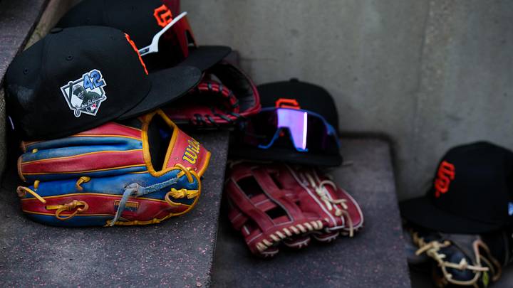 Apr 15, 2026; Cincinnati, Ohio, USA;  View of Giants game hats on the dugout steps, with a patch honoring Jackie Robinson during the game between the San Francisco Giants and the Cincinnati Reds at Great American Ball Park. Players and coaches will wear No. 42 in honor of Jackie Robinson Day around the league. Mandatory Credit: Aaron Doster-Imagn Images