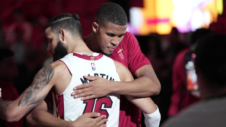 Dec 14, 2023; Miami, Florida, USA;  Miami Heat forward Caleb Martin (16) greets Miami Heat center Orlando Robinson (25) before the game against the Chicago Bulls at Kaseya Center. Mandatory Credit: Jim Rassol-USA TODAY Sports